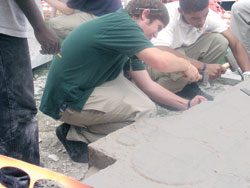 Earlier this year, Cathedral High School students Patrick McNulty and Mac Banks helped chisel and carve a Celtic cross in honor of Stephen McNulty, Patrick’s brother, who died in March from heart problems. The cross, which was recently completed and dedicated at the private Catholic high school in Indianapolis, now stands as a tribute to Stephen on the Cathedral campus. (Photo by John Shaughnessy) 