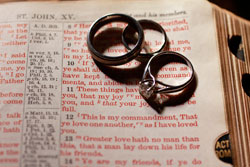 Newlyweds Steven and Ruth Moll were married on June 27 at St. Rose Church in Knightstown. Her engagement and wedding rings and his wedding ring placed on a Bible symbolize their marital covenant with God. (Photo by Kelly Kimball/Ingalls Photography) 