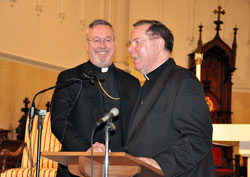 Videographers and reporters from Indianapolis television stations and newspapers participate in a Jan. 14 press conference at St. John the Evangelist Church in Indianapolis as Archbishop Daniel M. Buechlein introduces Bishop-designate Christopher J. Coyne. (Photo by Mary Ann Wyand)