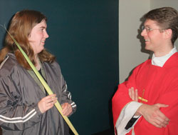 Father Sean Danda talks with University of Indianapolis senior Anne Marie Shipe after a Palm Sunday Mass on April 17 in the college’s chapel. In his first year as the Catholic chaplain at the university, Father Danda has brought the sacraments and a caring, priestly presence to students, according to Shipe, a member of Christ the King Parish in South Bend, Ind., in the Fort Wayne-South Bend Diocese. (Photo by John Shaughnessy)