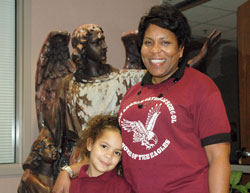 Sherlynn Pillow, right, shares a smile with Kalissa Larsuel, a first-grade student at Holy Angels School in Indianapolis, where Pillow is the principal and a firm believer in the guidance of angels. (Photo by John Shaughnessy)