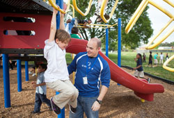 Seminarian Adam Ahern spends time with a young boy on April 25, 2012, at a Boys Club and Girls Club in Evansville, Ind. Ahern, a member of St. Anthony of Padua Parish in Morris, is in his second year of priestly formation at Saint Meinrad Seminary and School of Theology in St. Meinrad. (Photo courtesy of Saint Meinrad Archabbey)