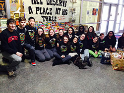 Cardinal Ritter Jr./Sr. High School students pose in front of canned goods they collected during their annual food drive for the needy in the Indianapolis area. (Submitted photo)