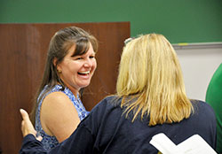 Lisa Whitaker chats with a fellow St. John Bosco conference youth ministry track participant before a session on July 14 at Franciscan University of Steubenville in Steubenville, Ohio. She serves as director of faith formation and youth ministry for Most Precious Blood Parish in New Middleton, St. Joseph Parish in Corydon and St. Peter Parish in Harrison County. (Photo by Natalie Hoefer) 