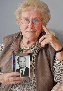 Maria Moko displays a photo of her husband, Leslie, at her home in Indianapolis on Nov. 12. The Mokos fled on foot at night to escape the Soviet invasion of Hungary in November 1956. (Photo by Natalie Hoefer)