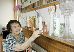 Nearing her 94th birthday, Santa Constantino Bayt shows her love for the Blessed Mother by lighting candles every day in her honor, asking for blessings for her family that extends to more than 400 people. (Photo by John Shaughnessy)