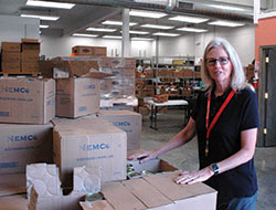 As the director of the Boulevard Place St. Vincent de Paul Food Pantry, Cindy Brown is all smiles about the improvements that were part of the recent physical transformation of the pantry building—improvements that have created a quicker, more comfortable shopping experience for people in need.  (Photo by John Shaughnessy)