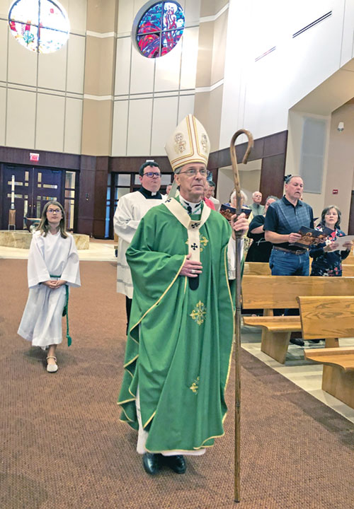 Archbishop Charles C. Thompson processes in St. Mary-of-the-Knobs Church in Floyd County on Oct. 10 to celebrate Mass during a United Catholic Appeal advance gathering event. Behind him are altar server Danica Faye, left, and archdiocesan director of worship Father James Brockmeier. (Photo by Leslie Lynch)