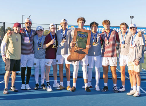 The players and coaches of the boys’ tennis team of Brebeuf Jesuit Preparatory School in Indianapolis pose with their Indiana State High School Athletic Association state championship trophy after their thrilling victory over the team from Center Grove High School on Oct. 19 in Indianapolis. (Photo courtesy of Mike Hoffbauer)