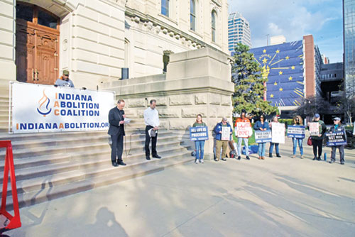 Archbishop Charles C. Thompson offers a prayer on the steps of the Indiana Statehouse in Indianapolis on Nov. 17 during a rally calling on Indiana Gov. Eric Holcomb to halt the execution of Joseph Corcoran, scheduled for Dec. 18, the first state execution in 15 years. (Photo by Sean Galllagher)