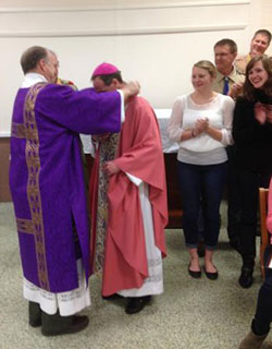 Deacon Charlie Koressel, left, presents Bishop Charles C. Thompson with the Bronze Pelican Award.